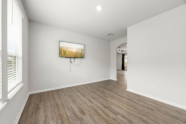 11323 Cora Ln, Willis, TX 77318 - unfurnished room with healthy amount of natural light, wood finished floors, a ceiling fan, arched walkways, and recessed lighting