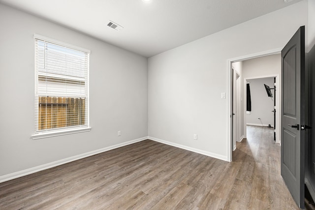 11323 Cora Ln, Willis, TX 77318 - spare room with wood finished floors and baseboards