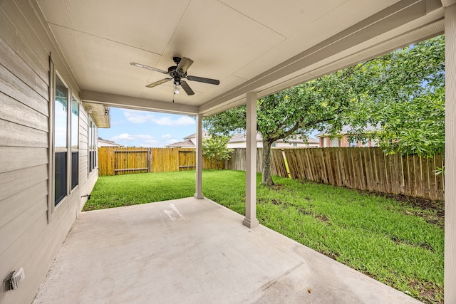 11323 Cora Ln, Willis, TX 77318 - fenced backyard with a ceiling fan and a patio area