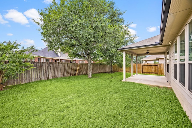11323 Cora Ln, Willis, TX 77318 - fenced backyard with a patio and ceiling fan