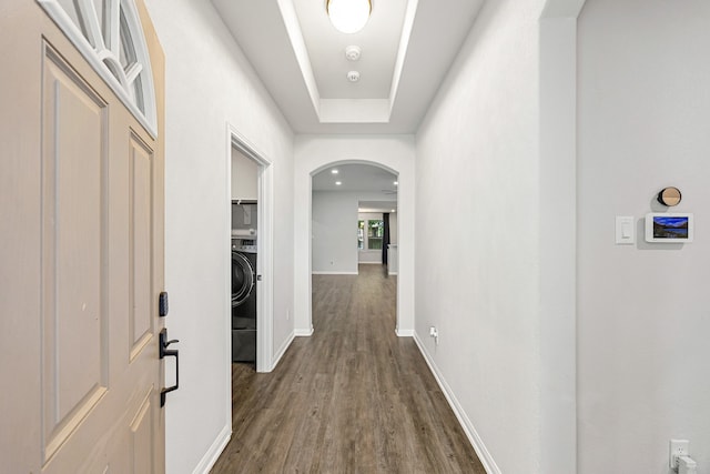 11323 Cora Ln, Willis, TX 77318 - hallway featuring arched walkways, dark wood-type flooring, and washer / clothes dryer