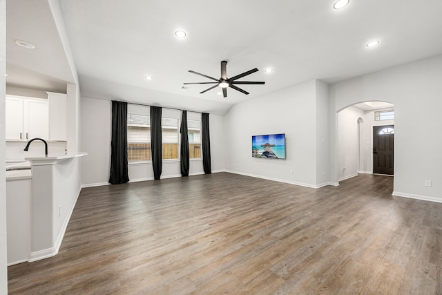 11323 Cora Ln, Willis, TX 77318 - unfurnished living room featuring plenty of natural light, arched walkways, a ceiling fan, recessed lighting, and wood finished floors