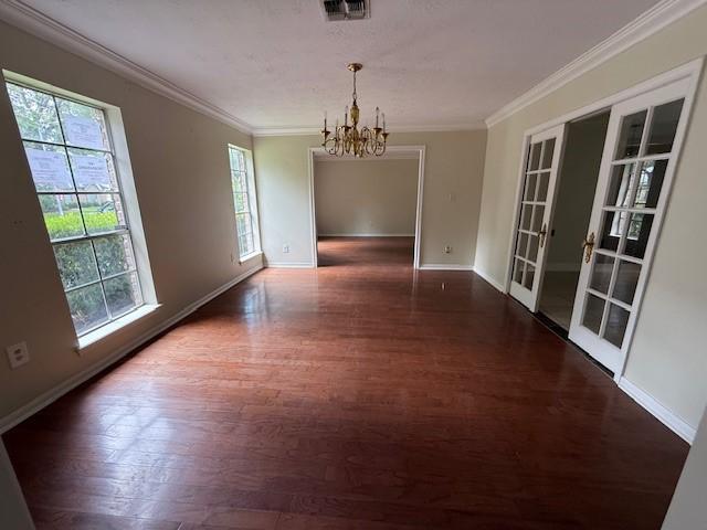 5914 Foresthaven Dr, Houston, TX 77066 - unfurnished dining area featuring a chandelier, french doors, dark wood-type flooring, and crown molding