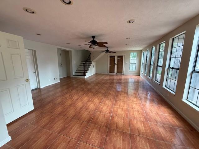 5914 Foresthaven Dr, Houston, TX 77066 - unfurnished living room with stairs, a ceiling fan, wood finished floors, and recessed lighting