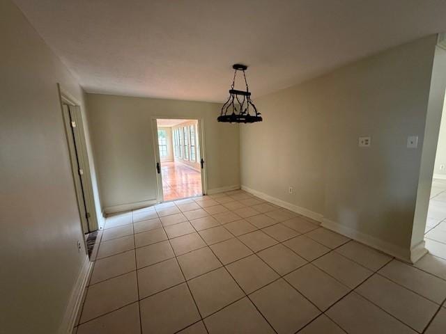5914 Foresthaven Dr, Houston, TX 77066 - unfurnished dining area featuring light tile patterned flooring and baseboards