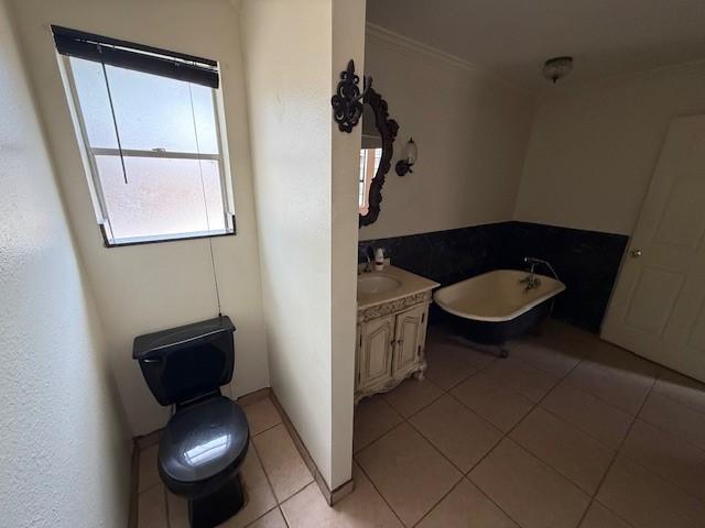 5914 Foresthaven Dr, Houston, TX 77066 - full bathroom with a soaking tub, vanity, tile patterned flooring, and ornamental molding