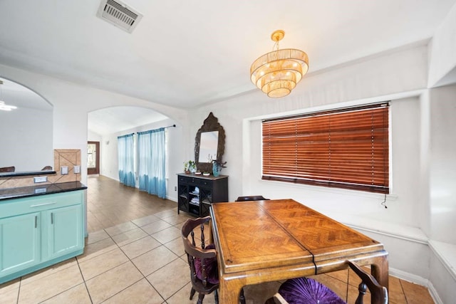 10919 Barker View Dr, Cypress, TX 77433 - dining room featuring light tile patterned floors, arched walkways, and a chandelier
