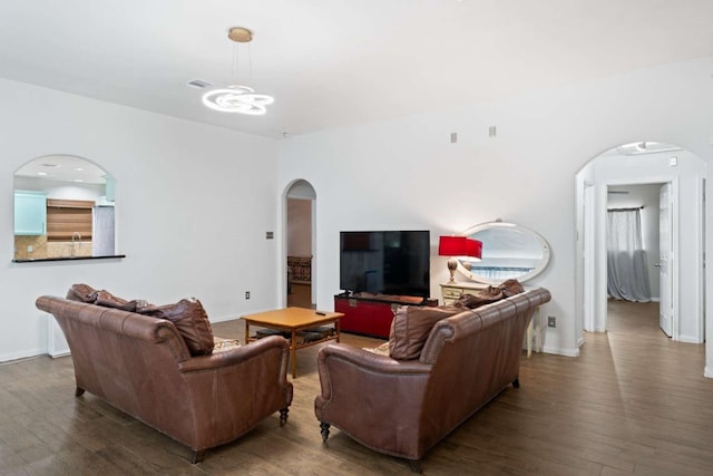 10919 Barker View Dr, Cypress, TX 77433 - living room with arched walkways, wood finished floors, and a chandelier
