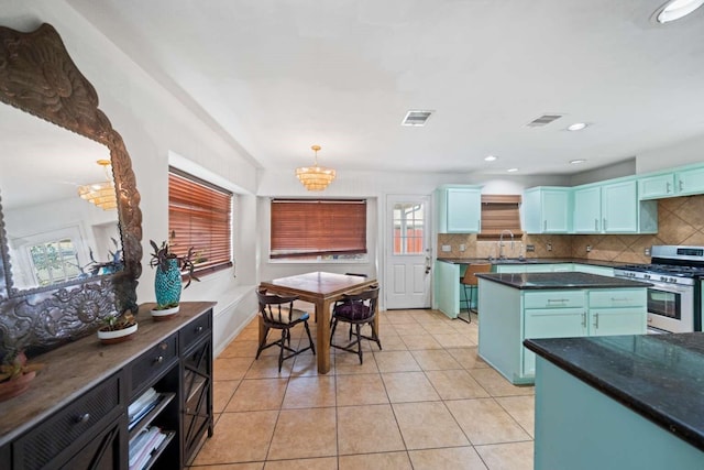 10919 Barker View Dr, Cypress, TX 77433 - kitchen featuring gas range, tasteful backsplash, dark countertops, and a chandelier