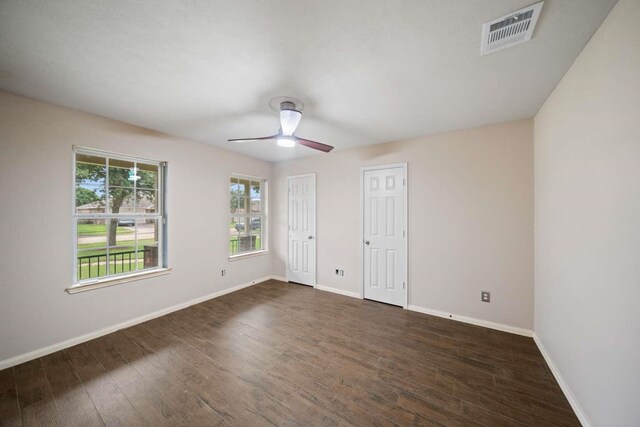 10919 Barker View Dr, Cypress, TX 77433 - unfurnished bedroom featuring dark wood-type flooring, multiple closets, and a ceiling fan