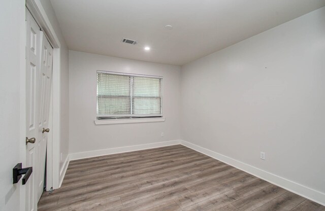 10415 Westray St, Houston, TX 77043 - unfurnished bedroom featuring wood finished floors, a closet, and recessed lighting