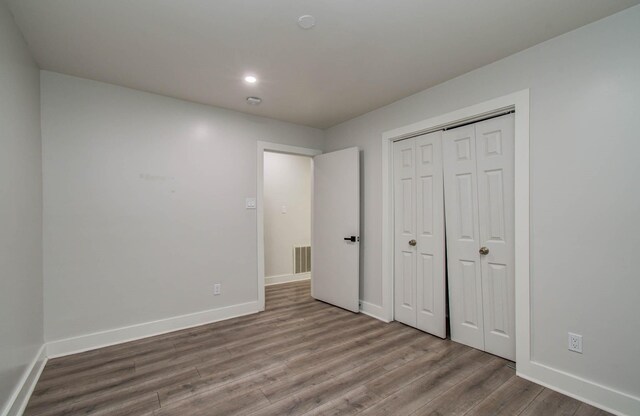 10415 Westray St, Houston, TX 77043 - unfurnished bedroom featuring wood finished floors, a closet, and recessed lighting