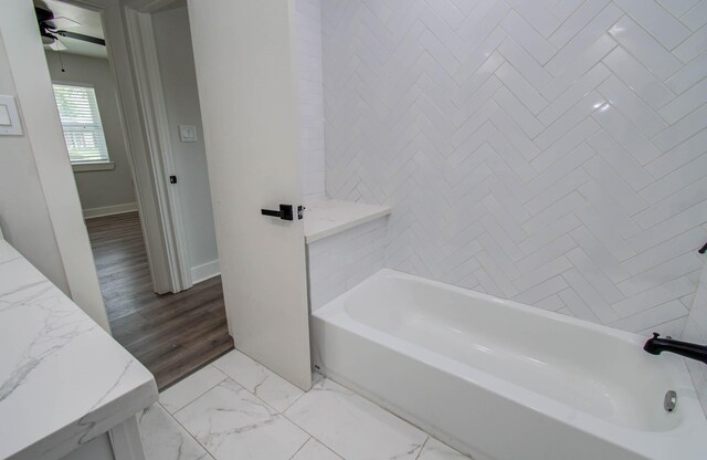 10415 Westray St, Houston, TX 77043 - full bath with marble look tiles, a ceiling fan, and bathtub / shower combination