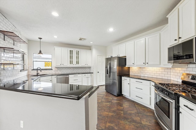 12823 Birch Falls Rd, Houston, TX 77065 - kitchen with stainless steel appliances, dark countertops, decorative backsplash, a peninsula, and recessed lighting