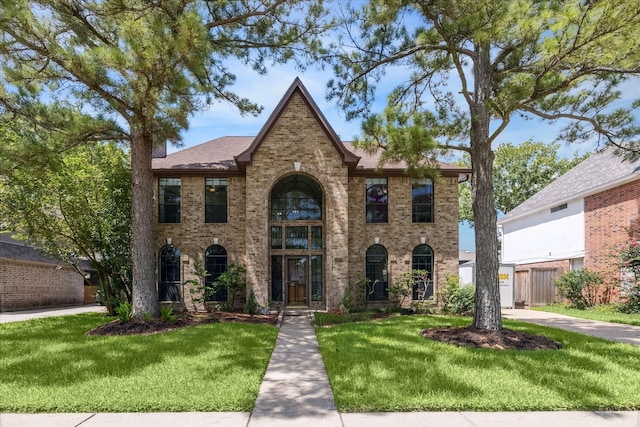 12823 Birch Falls Rd, Houston, TX 77065 - view of front of house with brick siding, a front yard, and a shingled roof