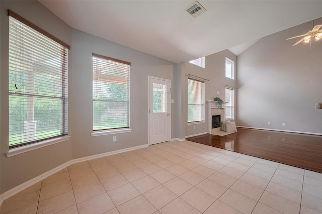 5403 Round Hollow Ct, Katy, TX 77494 - entrance foyer with light tile patterned floors, vaulted ceiling, a tiled fireplace, and a ceiling fan