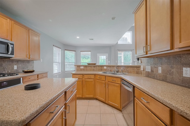 5403 Round Hollow Ct, Katy, TX 77494 - kitchen featuring stainless steel appliances, light tile patterned floors, backsplash, a peninsula, and light stone countertops