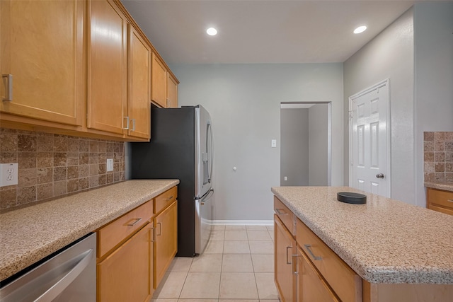 5403 Round Hollow Ct, Katy, TX 77494 - kitchen with stainless steel appliances, tasteful backsplash, a kitchen island, light tile patterned floors, and recessed lighting