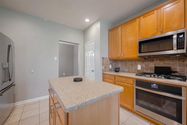 5403 Round Hollow Ct, Katy, TX 77494 - kitchen featuring stainless steel appliances, light tile patterned flooring, tasteful backsplash, a center island, and recessed lighting