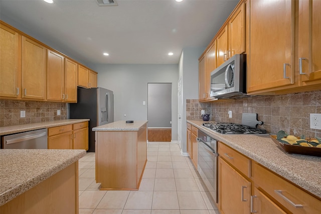 5403 Round Hollow Ct, Katy, TX 77494 - kitchen featuring appliances with stainless steel finishes, light tile patterned flooring, recessed lighting, backsplash, and a kitchen island