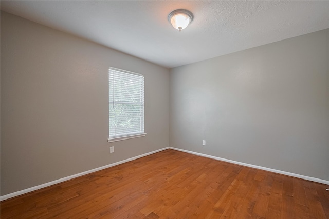 5403 Round Hollow Ct, Katy, TX 77494 - spare room with wood finished floors and baseboards