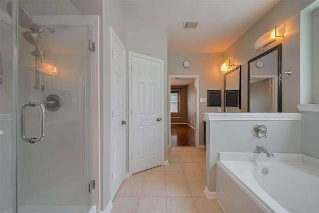 5403 Round Hollow Ct, Katy, TX 77494 - bathroom featuring a stall shower, a garden tub, and tile patterned floors