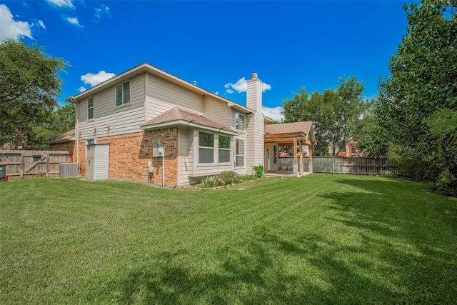 5403 Round Hollow Ct, Katy, TX 77494 - back of property featuring brick siding, a chimney, a fenced backyard, and a patio area