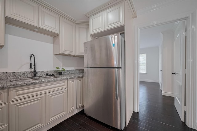 2333 Bering Dr Unit 334, Houston, TX 77057 - kitchen featuring freestanding refrigerator, dark wood finished floors, light stone countertops, and white cabinetry