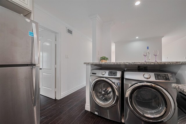 2333 Bering Dr Unit 334, Houston, TX 77057 - laundry room with washer and clothes dryer, dark wood-type flooring, ornamental molding, and recessed lighting