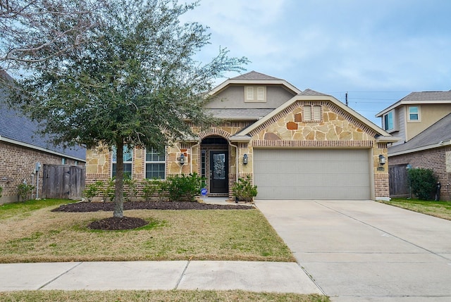 23334 Peareson Bend Ln, Richmond, TX 77469 - view of front of home featuring stone siding, an attached garage, and concrete driveway