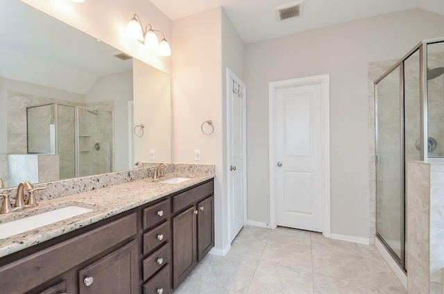 23334 Peareson Bend Ln, Richmond, TX 77469 - bathroom with lofted ceiling, double vanity, a stall shower, and tile patterned flooring