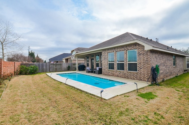 23334 Peareson Bend Ln, Richmond, TX 77469 - back of property with brick siding, a fenced backyard, a shingled roof, and a patio area