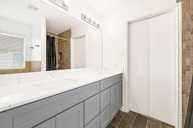 129 Breezy Shore Ct, Dickinson, TX 77539 - bathroom with double vanity and a tile shower