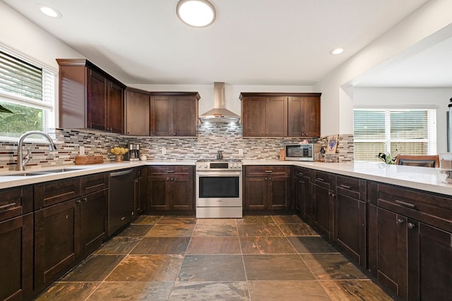 129 Breezy Shore Ct, Dickinson, TX 77539 - kitchen featuring wall chimney exhaust hood, appliances with stainless steel finishes, light countertops, tasteful backsplash, and recessed lighting