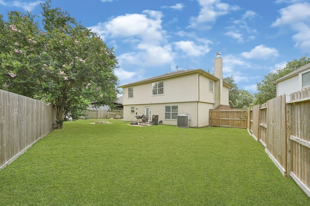 129 Breezy Shore Ct, Dickinson, TX 77539 - back of property with a fenced backyard, stucco siding, and a chimney