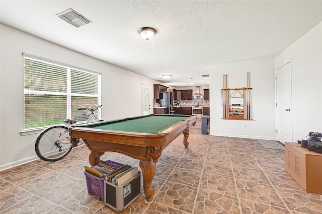 129 Breezy Shore Ct, Dickinson, TX 77539 - game room featuring stone floors, pool table, and a textured ceiling