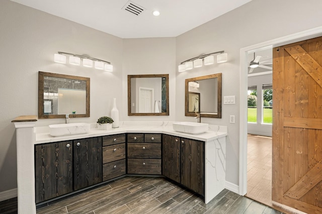 4946 Westchester Dr, Fulshear, TX 77441 - full bathroom with double vanity and wood finished floors