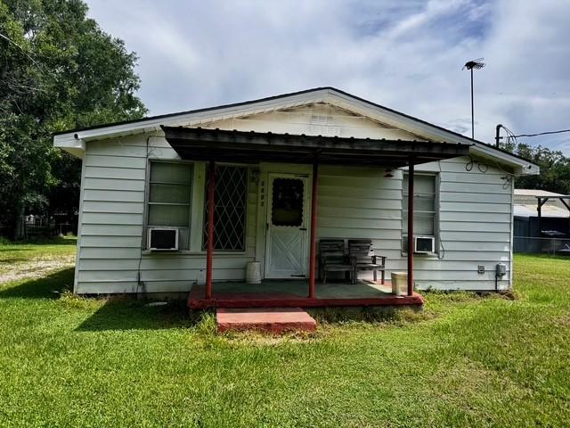 2803 Horn Rd, Bay City, TX 77414 - back of house with a lawn and cooling unit