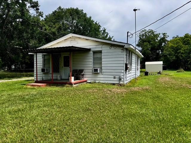 2803 Horn Rd, Bay City, TX 77414 - view of front of home with covered porch, a front lawn, and cooling unit