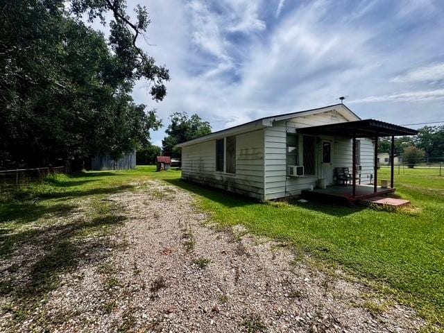 2803 Horn Rd, Bay City, TX 77414 - view of side of home with a lawn, driveway, and cooling unit