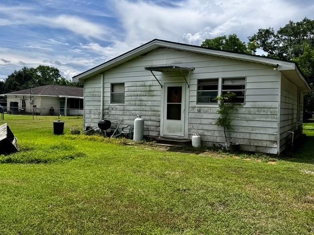 2803 Horn Rd, Bay City, TX 77414 - rear view of house with a yard