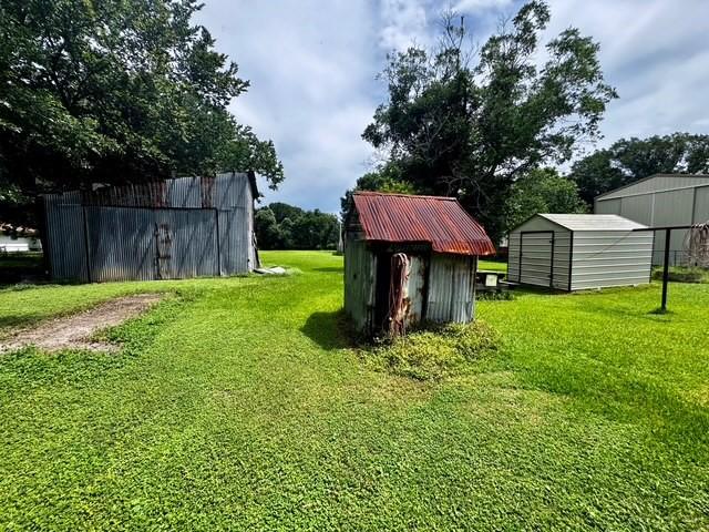 2803 Horn Rd, Bay City, TX 77414 - view of grassy yard with a storage unit