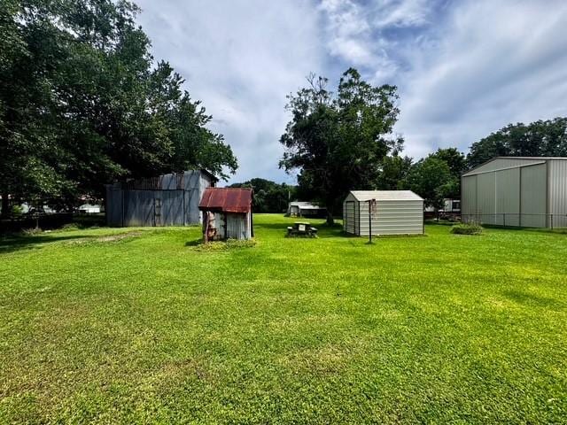 2803 Horn Rd, Bay City, TX 77414 - view of green lawn with a storage unit and a pole building