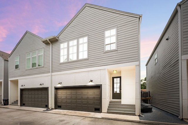 6033 Cypress St, Houston, TX 77074 - view of front facade featuring an attached garage and concrete driveway