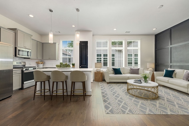 6033 Cypress St, Houston, TX 77074 - living room with dark wood-style flooring and recessed lighting