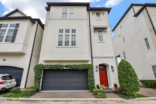 2230 Lakeshore Edge Dr, Houston, TX 77080 - view of front facade featuring an attached garage, stucco siding, and driveway