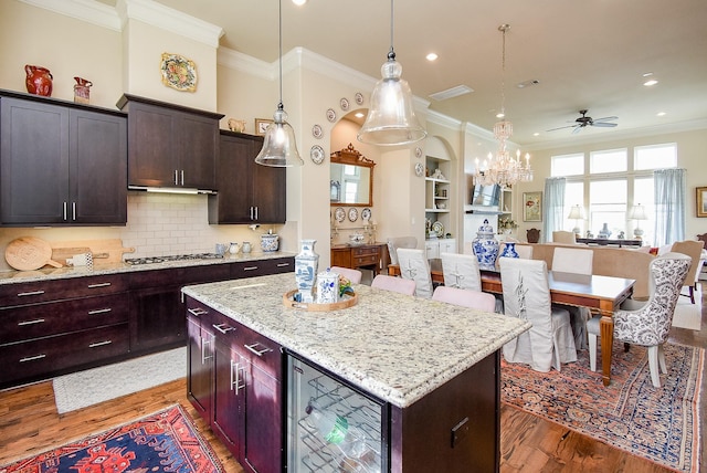 2230 Lakeshore Edge Dr, Houston, TX 77080 - kitchen featuring open floor plan, wood finished floors, stainless steel gas stovetop, a ceiling fan, and crown molding