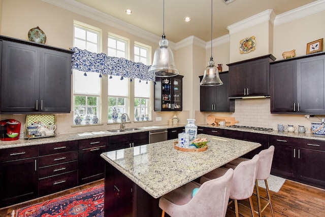 2230 Lakeshore Edge Dr, Houston, TX 77080 - kitchen featuring a breakfast bar, crown molding, dark wood-style floors, stainless steel appliances, and a center island