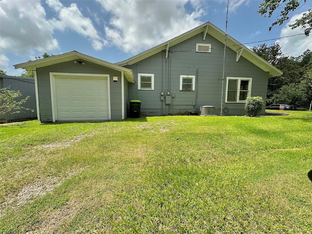 716 Olive St, Wharton, TX 77488 - back of house featuring a lawn, driveway, and a garage