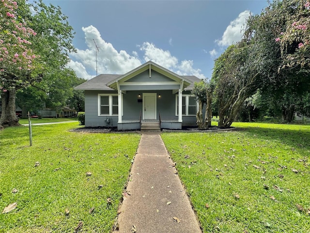 716 Olive St, Wharton, TX 77488 - bungalow-style house featuring a porch and a front lawn